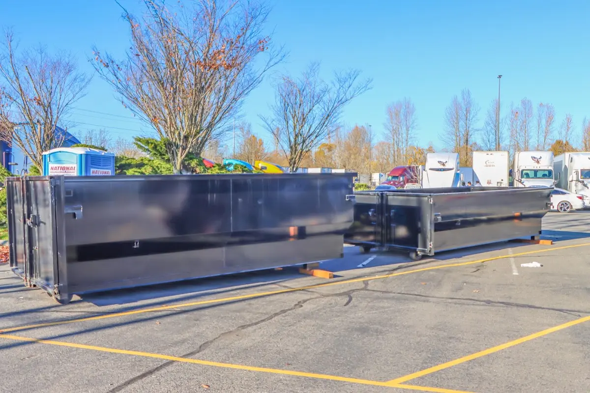 Professional dumpster rental service with roll-off container on residential driveway in Mount Carmel